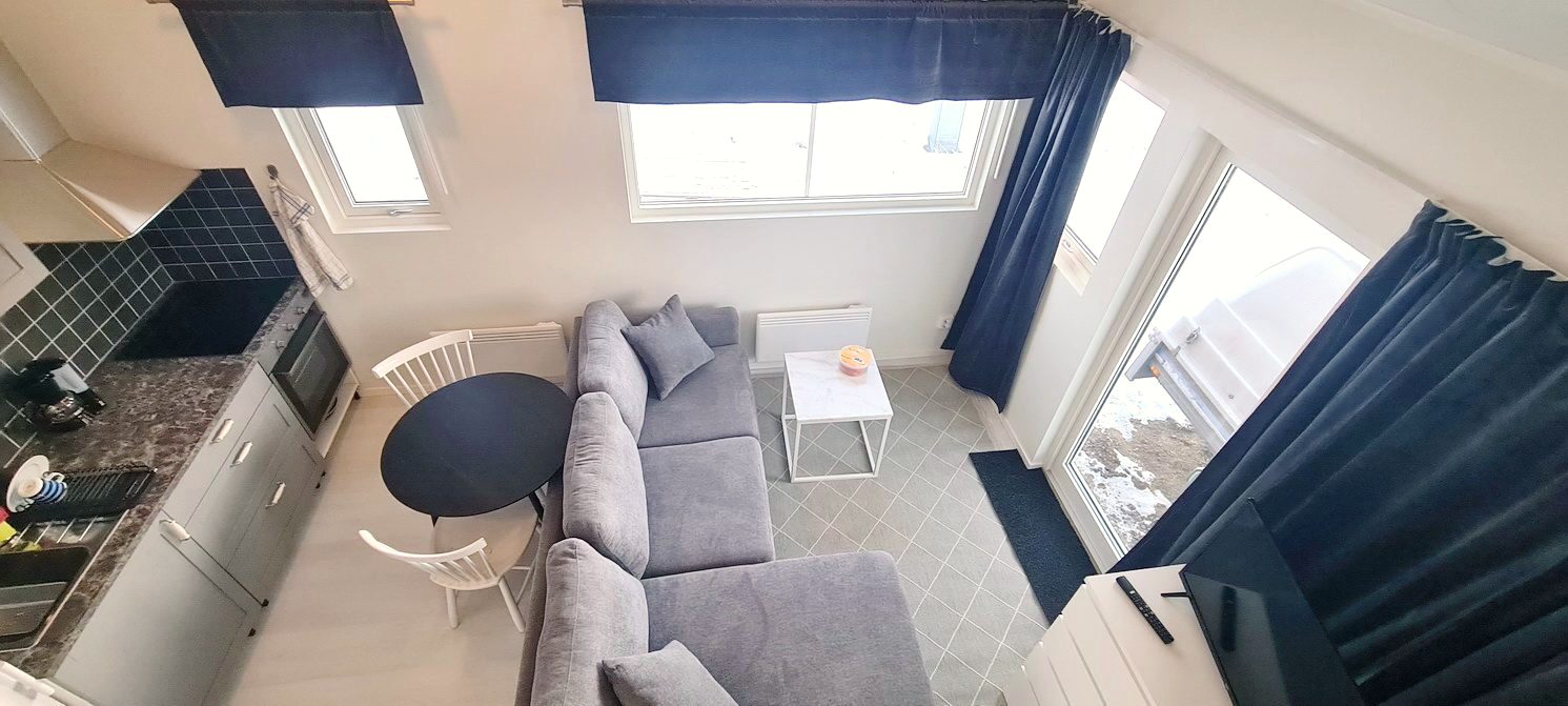 Modern compact accommodation unit with kitchen and living area